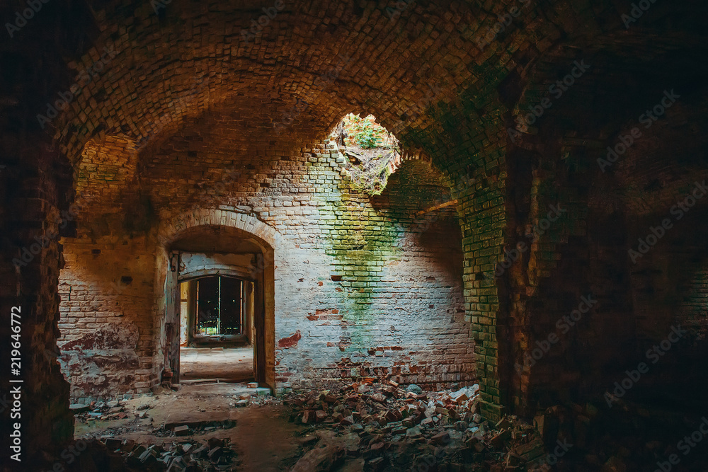 Fototapeta premium Ruined ancient brick temple inside interior with doors, corridors and arch