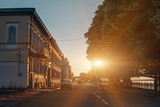 Sunset at small European town in warm summer evening with ancient architecture and trees, toned