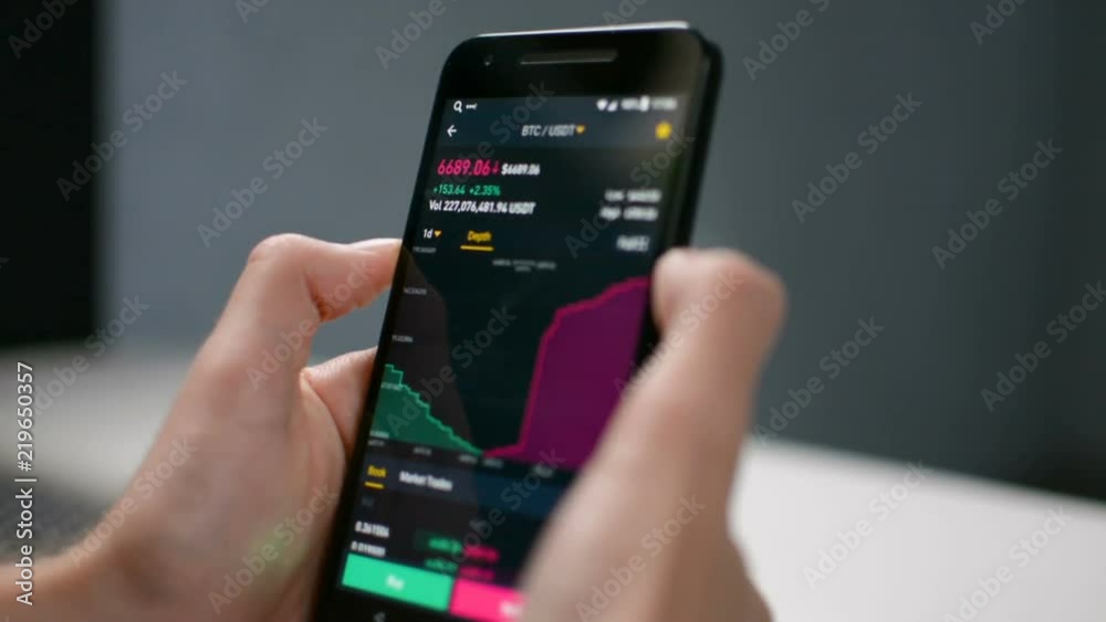 Businessman is looking at Bitcoin price deapth chart on digital exchange on mobile phone screen, cryptocurrency future price action prediction concept Businessman is looking at Bitcoin price deapth chart on digital exchange on mobile phone screen, cryptocurrency future price action prediction concept