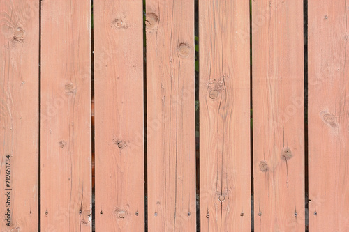 Vertical boards with knots. Fence from flat rails. Background with old wood texture.