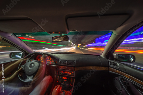 Night city road view from inside car © pozdeevvs