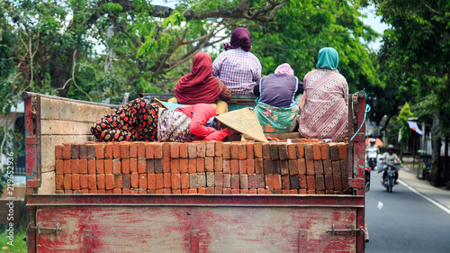 Group of muslim women travelling on a truck in a city in Indonesia, Lombok photo