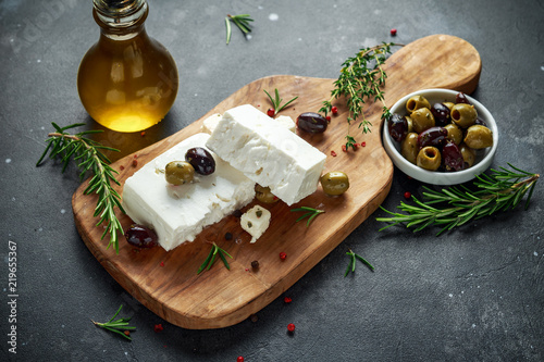 Greek cheese feta with thyme, rosemary and olives photo