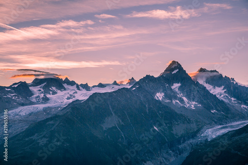 Crimson Sunrise over Mont-Blanc Snowy Peaks and Glaciers with Clouds