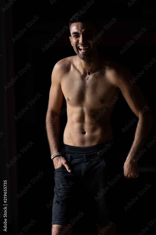 Laughing young shirtless man