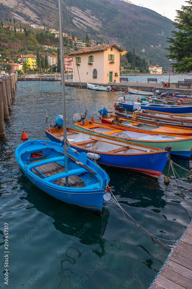 Berth with boats in the town of Riva del Garda. Italy. Pier in Riva del Garda.