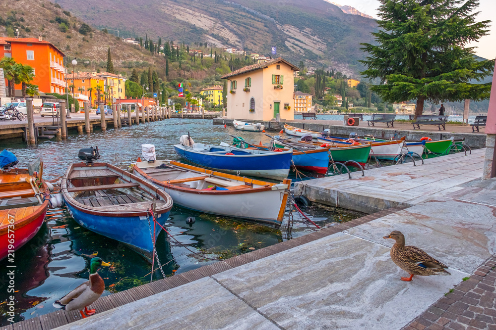 Berth with boats in the town of Riva del Garda. Italy. Pier in Riva del Garda.
