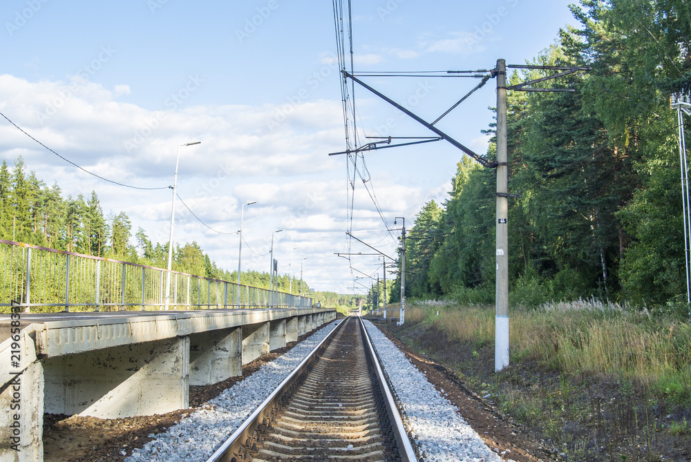 A view at the and railroad sleepers going through the forest