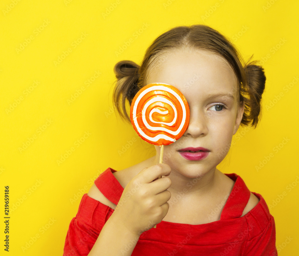 Beautiful young woman holds in hand candy