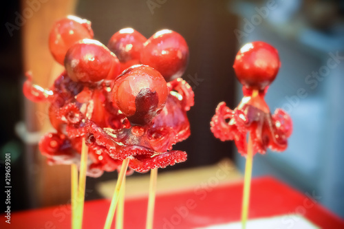 Delicious grilled baby octopus street food at Kuromon Ichiba Market, Osaka photo