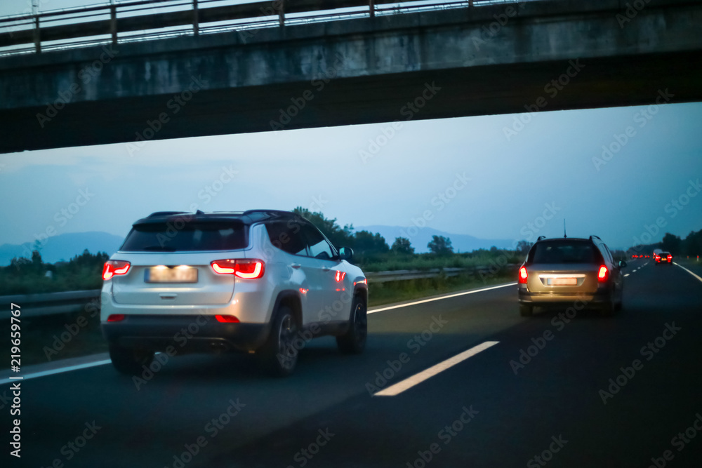 Fototapeta premium Traffic on the highway at sunset