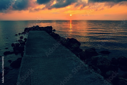 Sunset - sunrise by the sea on the beach. Beautiful romantic landscape with nature.