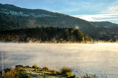 cold morning dust floating over norwegian landscape