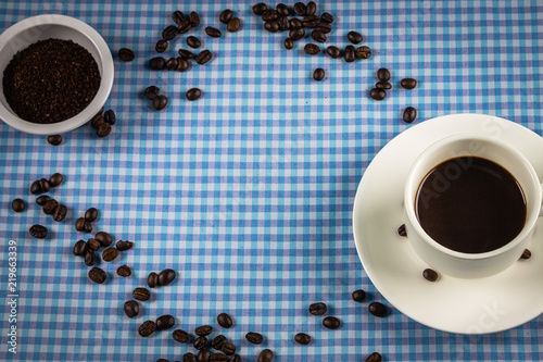 Coffee cup and coffee beans on table