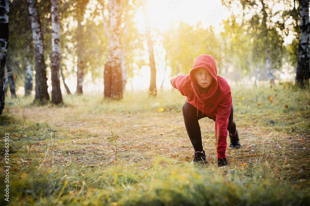 Focused woman exercising in the city park. Sports. Focused woman exercising in the city park. Sports.