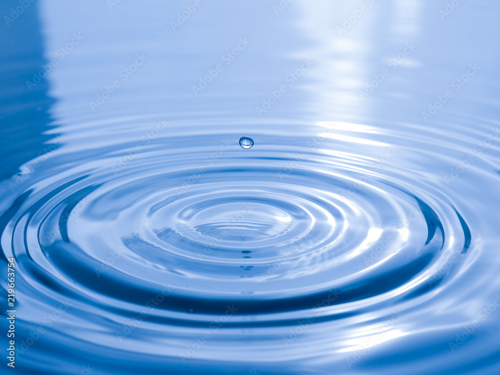 close up drop of water on blue background close up drop of water on blue background