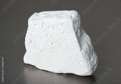 Specimen of mineral kaolinite (kaolin) on gray background photo