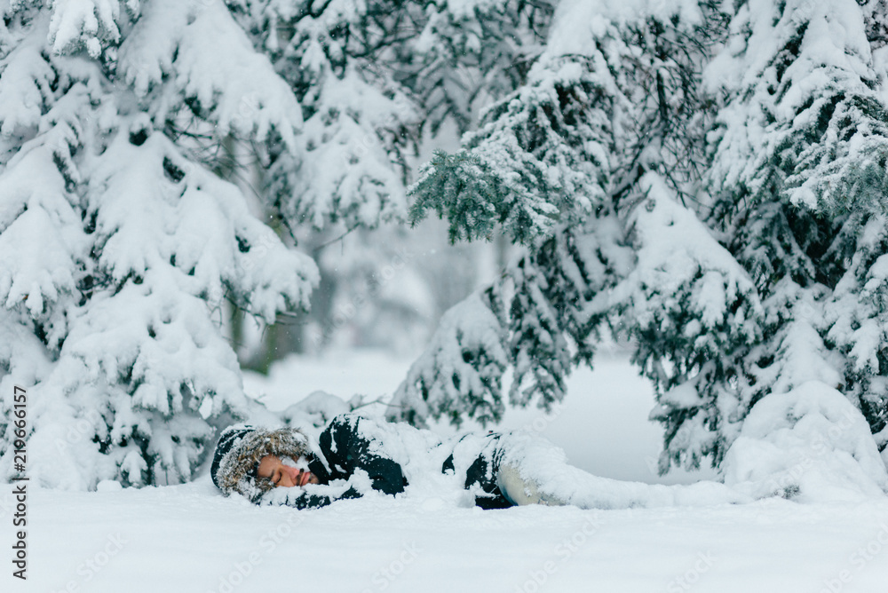 Man in snow. Homeless male sleeping outdoor under trees. Odd bizarre shocked traveler guy freezing on ground in frost winter day. Unique person lifestyle. Overcoming challenges. Destination complete. Man in snow. Homeless male sleeping outdoor under trees. Odd bizarre shocked traveler guy freezing on ground in frost winter day. Unique person lifestyle. Overcoming challenges. Destination complete.