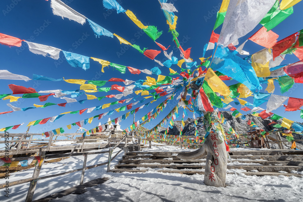 4500 m above sea level signage with hanging prayer flag at the peak of Shika snow mountain in Blue Moon Valley National Park, Shangri La, Yunnan, China