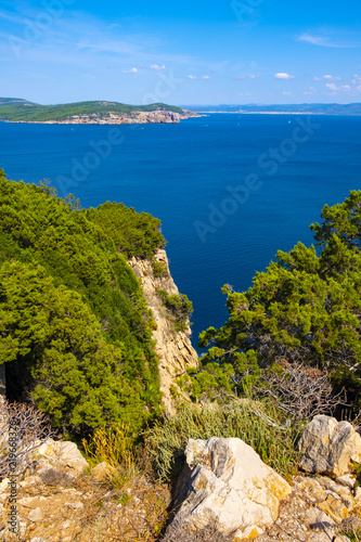 Alghero, Sardinia, Italy - Panoramic view of the Gulf of Alghero with cliffs of Punta del Giglio and city of Alghero in background