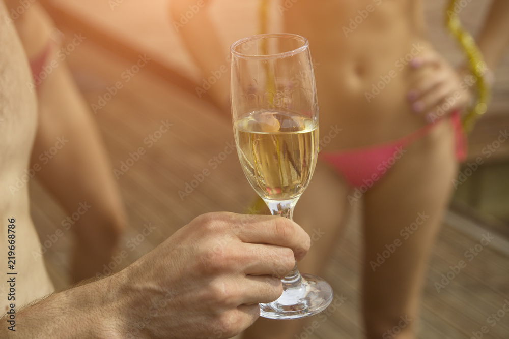 Man's hand holds a glass of champagne