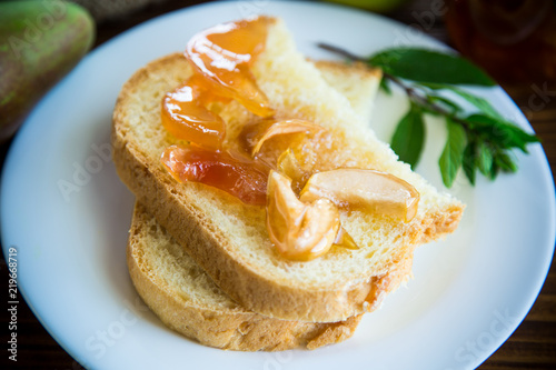 pieces of bread with sweet home-made fruit jam from pears and apples in a plate