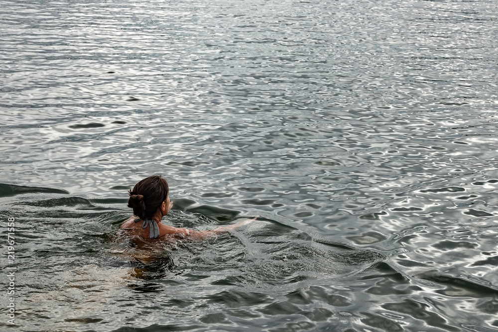 Woman swimming in the ocean. Copy space
