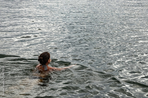 Woman swimming in the ocean. Copy space