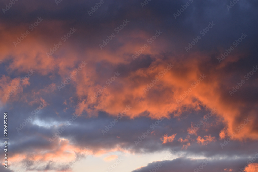 Storm sky at sunset. Background.
Orange and grey shaggy clouds obscured the evening sky.
