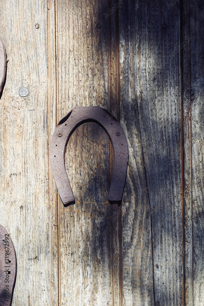horse shoes oxides on wooden door