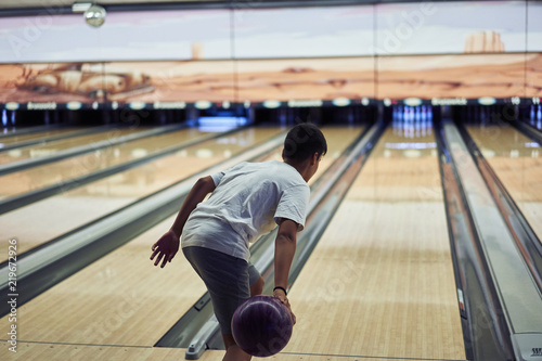 Young boy playing bowling