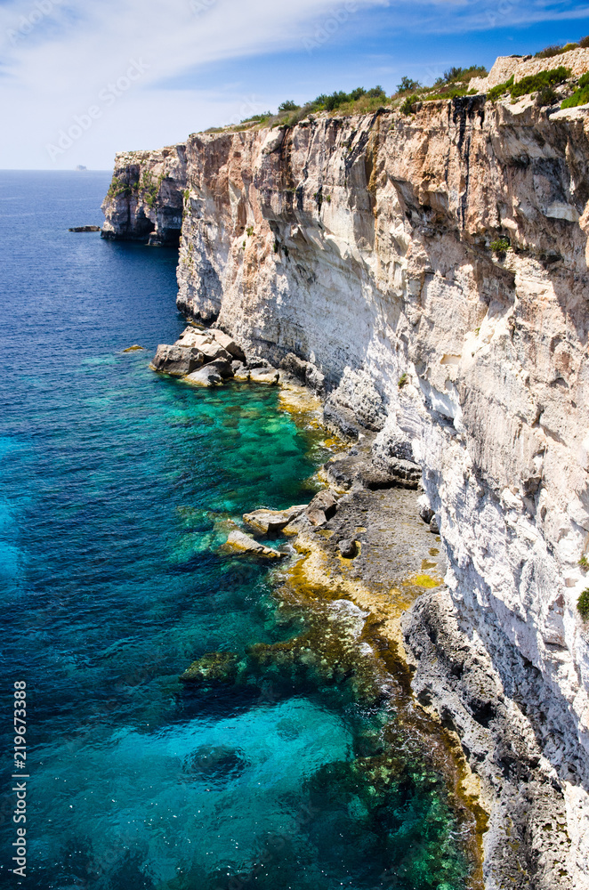 View of azure blue sky and sea around cliffs on mediterranean Malta coast coastline