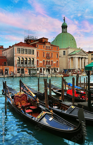Gondolas with San Simeon Piccolo church in background in Venice, Italy