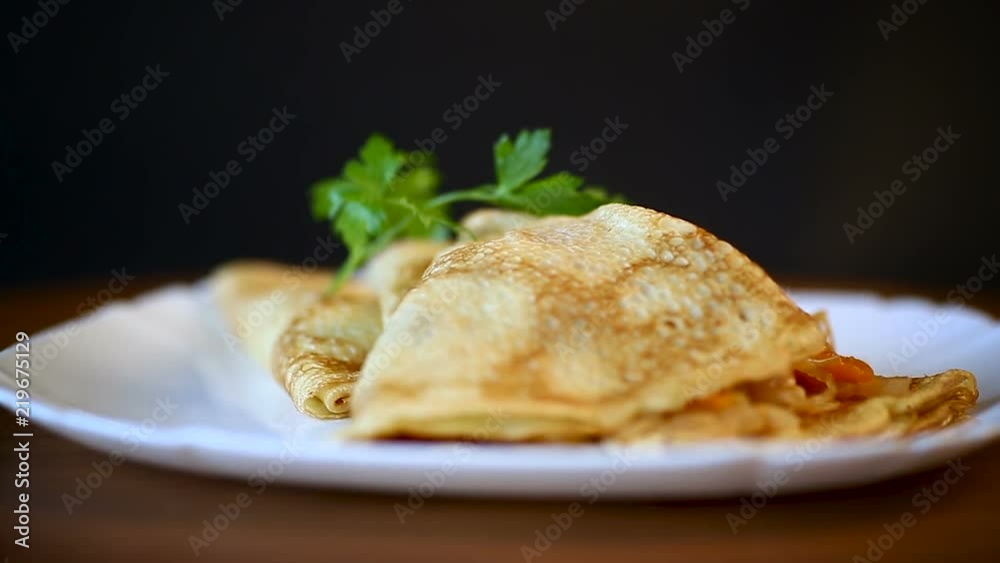 thin fried pancakes stuffed with stewed cabbage in a plate thin fried pancakes stuffed with stewed cabbage in a plate