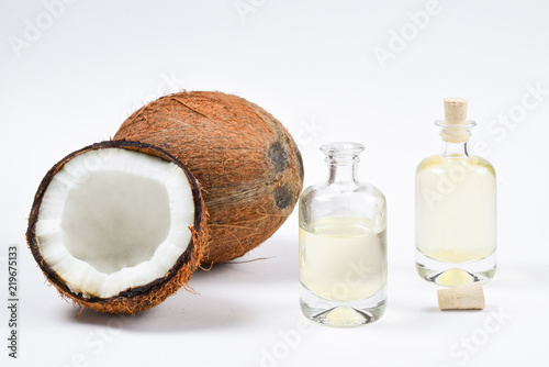 Natural coconut oil in bottles on white background.