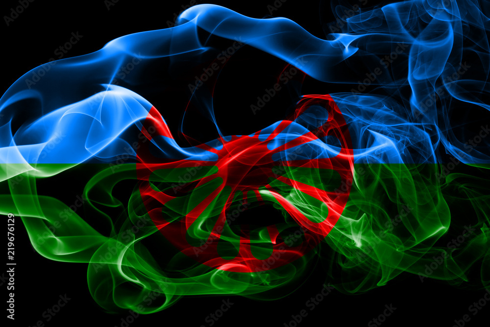 National flag of Gipsy made from colored smoke isolated on black background. Abstract silky wave background.