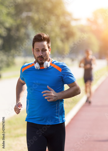 Man jogging on track in morning