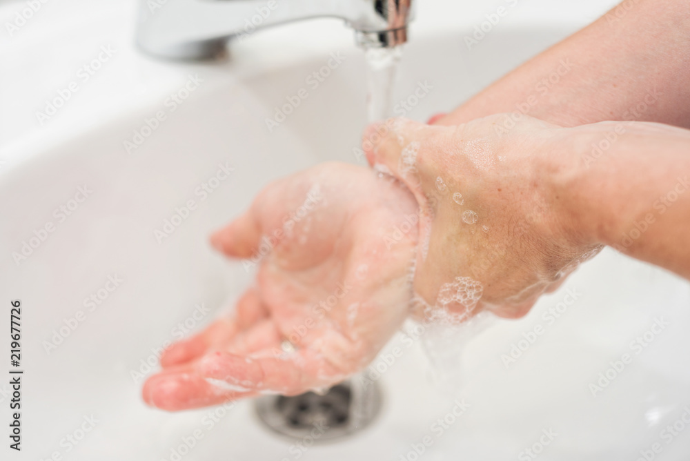 Young woman washing her hands Young woman washing her hands