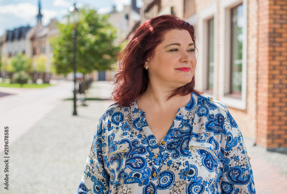 Fototapeta premium Pretty american middle age woman in vacation or at city. Size plus and xxl woman. Life of plump people in everyday life, faith in herself. Concept of life modern woman 