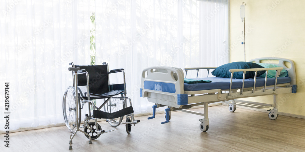 Fototapeta premium Hospital room with empty bed,infusion set , intravenous fluid and wheelchairs to creative for design and decoration on background.Copy space.