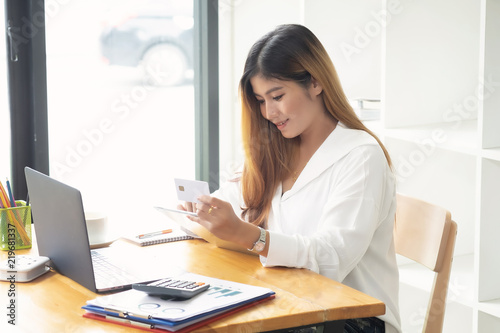 Shopping online concept, woman using laptop computer and tablet digital online shopping with credit card.