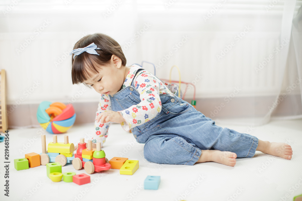baby girl play toy blocks at home