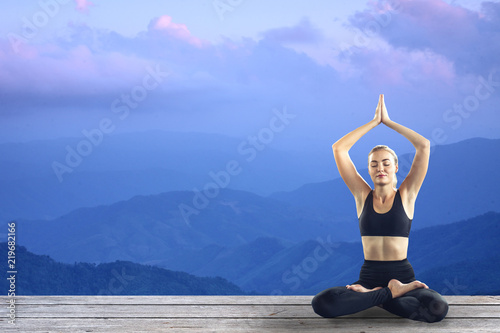 Young attractive smiling woman practicing yoga, sitting.Young beautiful woman practicing yoga and gymnastic. Wellness concept in gym