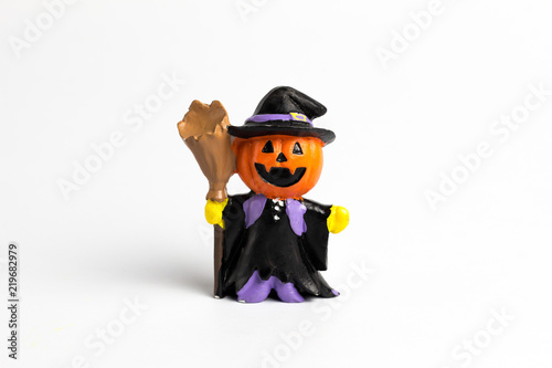 Wizard doll halloween pumpkin with a broom.