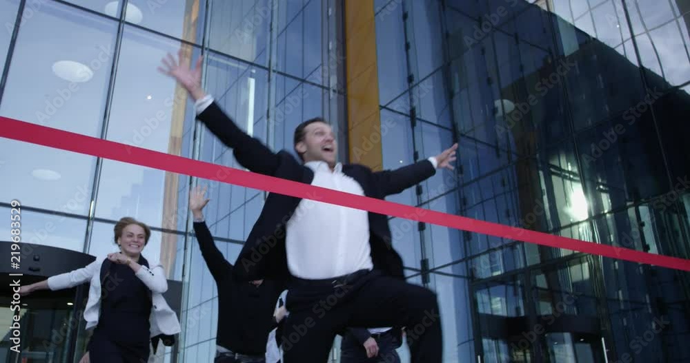 Business people crossing the finish line