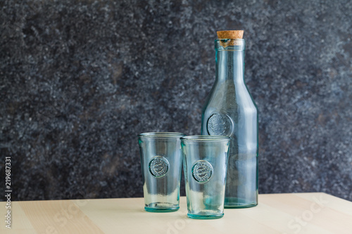 glassware and bottle glassware and bottle of recycled glass for wine on the table with cheese, grape and breadof recycled glass for wine on the table with cheese and bread