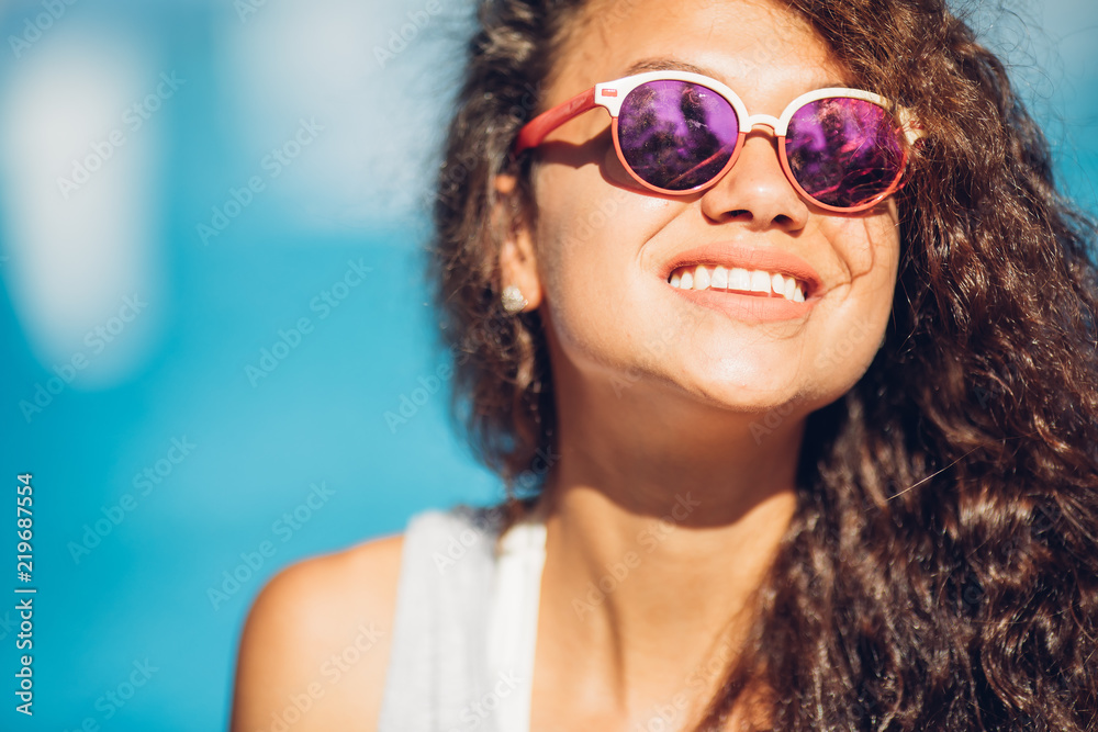 Positive summertime portrait of stylish girl having fun near pool, trendy outfit and sunglasses, traveling vibes, amazing view on luxury pool.Sexy perfect fit body woman. Copy, empty space for text Positive summertime portrait of stylish girl having fun near pool, trendy outfit and sunglasses, traveling vibes, amazing view on luxury pool.Sexy perfect fit body woman. Copy, empty space for text
