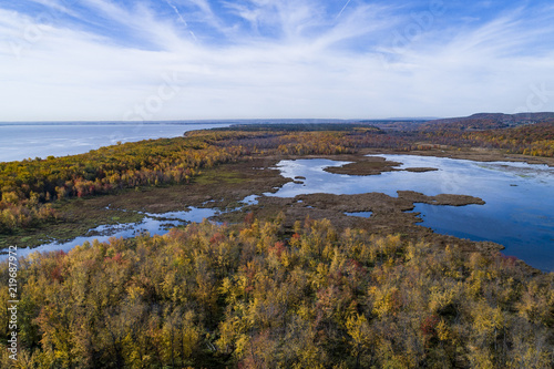 Aerial view over forest and marsh during vibrant autumn colors