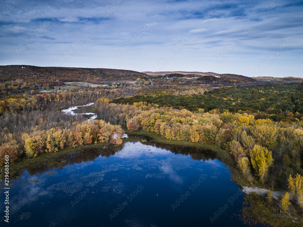 Aerial view over forest and river during vibrant autumn colors vibrant autumn colors