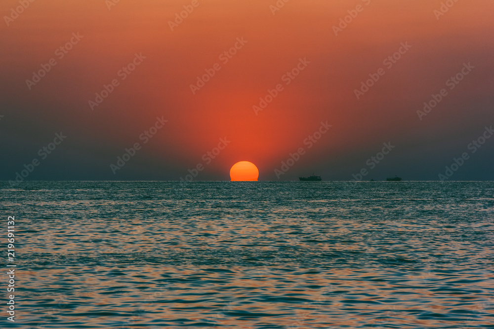 seascape with the setting sun and ships